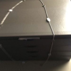 Kendra Scott long silver necklace with stones.